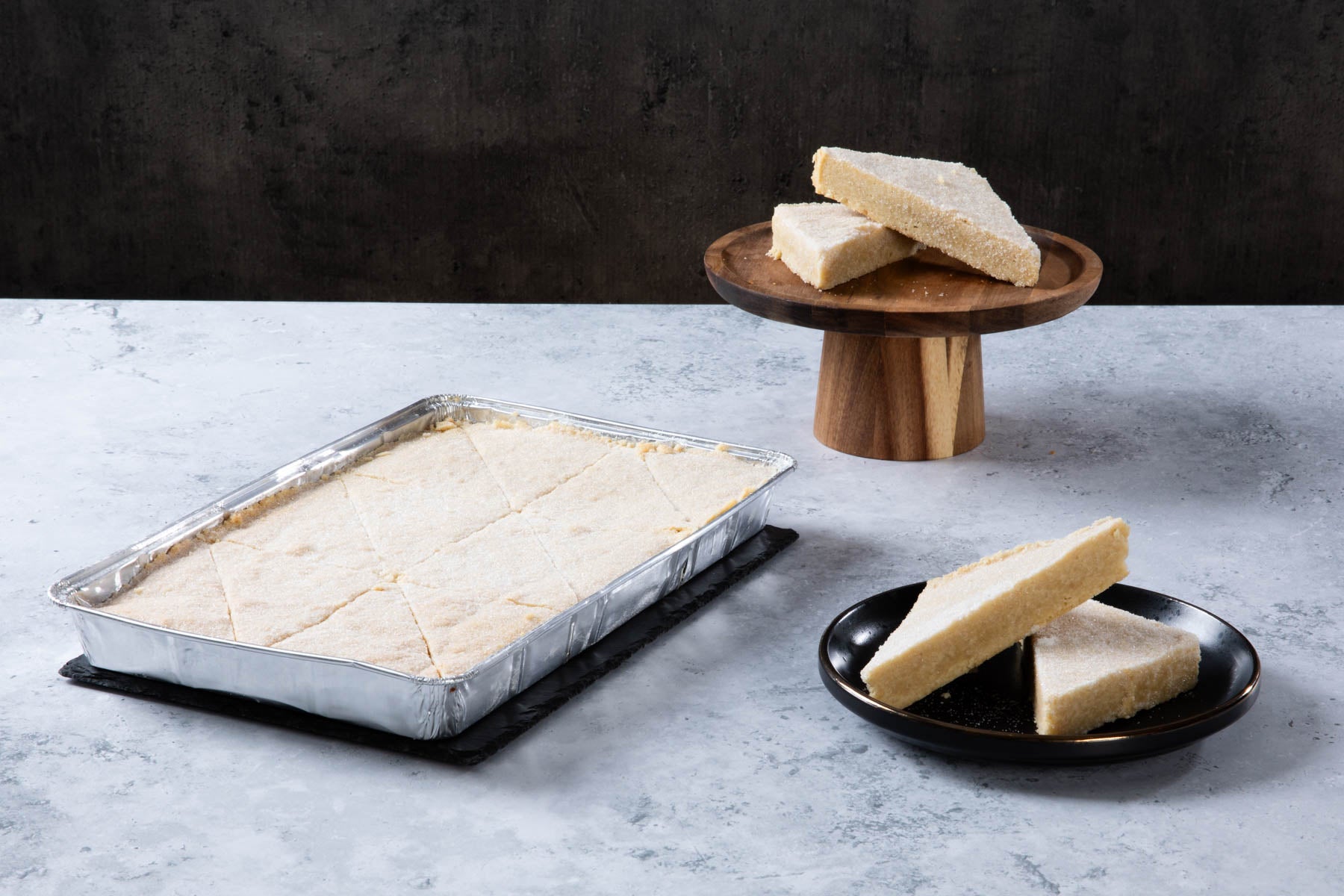 LHMC004-153.jpg Shortbread slices in a baking tray and on plates.
