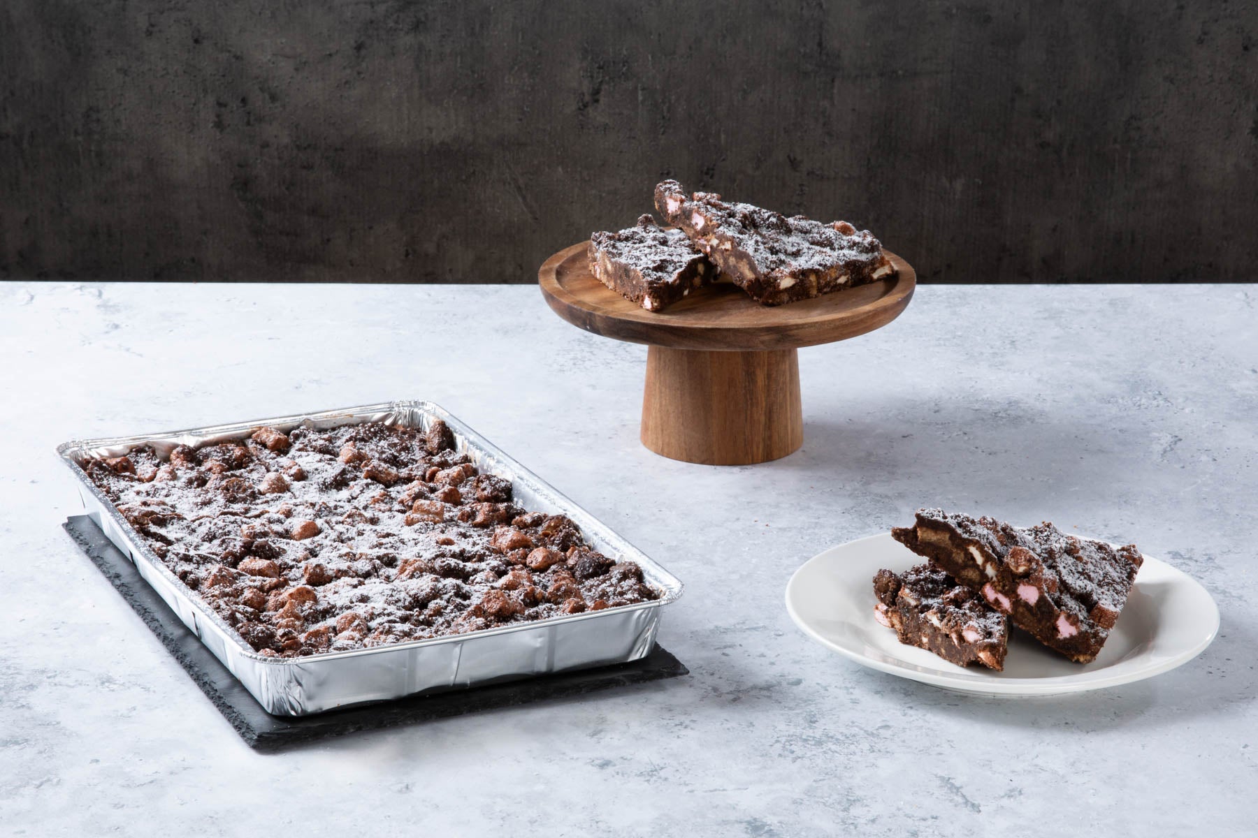 LHMC004-315.jpg Chocolate rocky road traybake with sliced pieces and icing sugar.